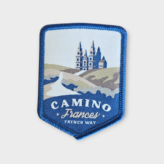 Camino Frances depicted on a hiking patch on grey background