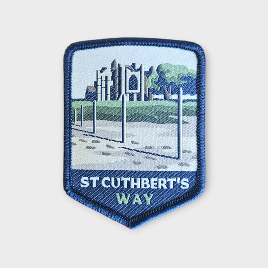 st cuthberts way depicted on a hiking patch on grey background