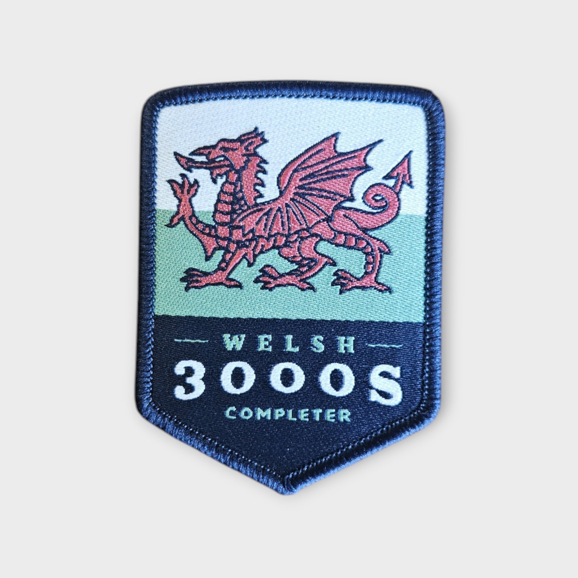Welsh 3000s depicted on a hiking patch with the welsh flag and dragon